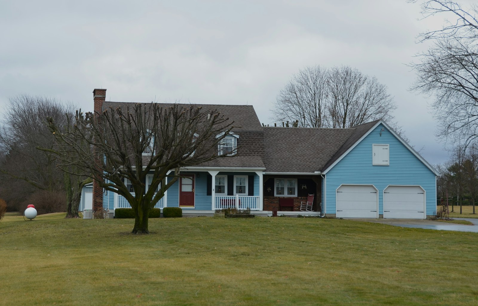a blue house with a tree in front of it